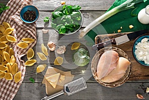 Raw ingredients for cooking Italian pasta on wooden table