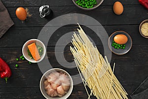 Raw ingredients cooking udon noodles chicken meat dark wooden table top view