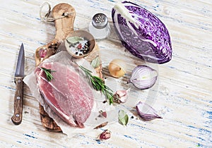 Raw ingredients - meat, red cabbage, onion, garlic, spices and herbs. Cooking delicious and healthy lunch.