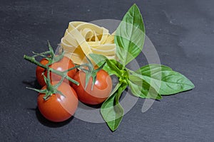 Raw ingredients for tomato and basil pasta