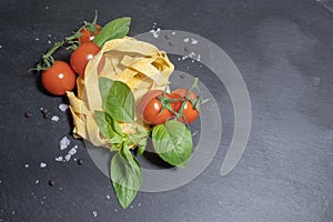 Raw ingredients for tomato and basil pasta