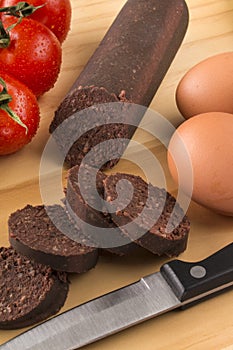 Raw irish black pudding on a wooden board