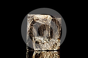 Raw iron pyrite cubical mineral stone in front of black background