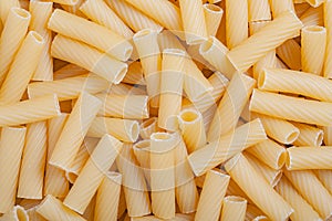 Raw italian durum wheat pasta tortiglioni background top view