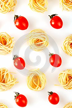 Raw italian pasta with tomatoes creative pattern on a white background