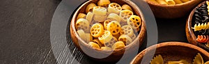 Raw Italian pasta in wooden bowl