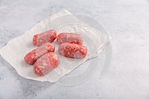 Raw Italian sausage, delicious small Salsiccia sausages with herbs photo
