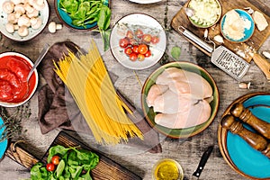 Raw Italian spaghetti with ingredients for preparing pasta