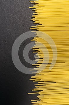 Raw Italian spaghetti pasta on gray background