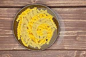 Raw italian torti pasta on brown wood