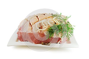 Raw juicy pork with cutted scored skin isolated on a white