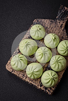 Raw khinkali or green dumplings with salt, spices and herbs