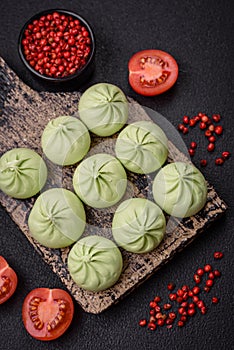 Raw khinkali or green dumplings with salt, spices and herbs