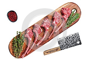 Raw Lamb chop steak on butcher board with rosemary and thyme. Isolated, white background.