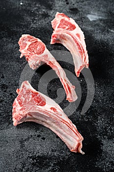 Raw lamb chops, Rack of Lamb. Black background. Top view
