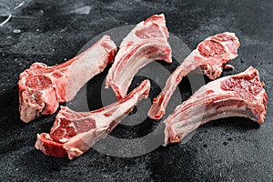 Raw lamb chops, Rack of Lamb. Black background. Top view