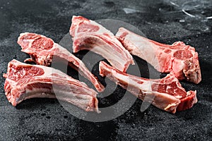 Raw lamb chops, Rack of Lamb. Organic meat steak. Black background. Top view