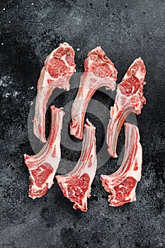 Raw lamb chops, Rack of Lamb. Organic meat steak. Black background. Top view