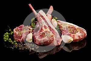 Raw lamb chops with spices and herbs