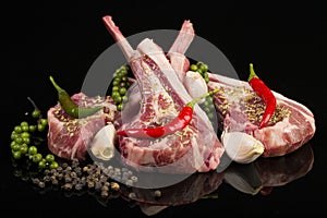 Raw lamb chops with spices and herbs