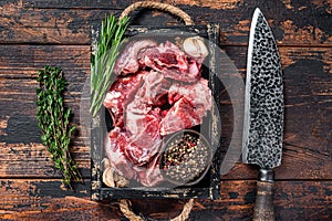 Crudo agnello O una capra cubi carne in umido osso. buio di legno. 