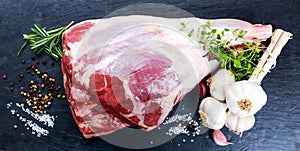 Raw lamb leg on blue stone background