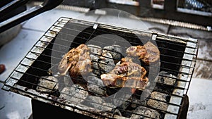 raw lamb meat marinated with sauce cooked on a hot smoky charcoal grill
