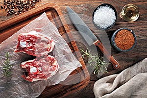 Raw lamb neck meat on white cooking paper and wooden cutting table