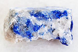 raw lapis lazuli stone on white marble
