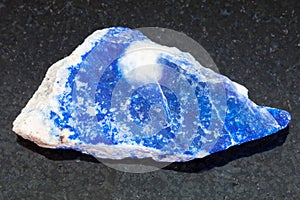 raw lazurite (lapis lazuli) stone on dark