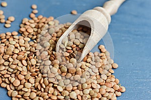 Raw lentils on a wooden spoon