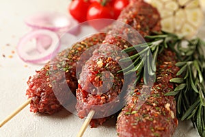 Raw lula kebab, herbs and spices, close up
