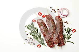 Raw lula kebab, herbs and spices on white background