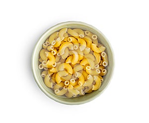 Raw macaroni pasta in bowl. Uncooked rigatoni isolated on white background