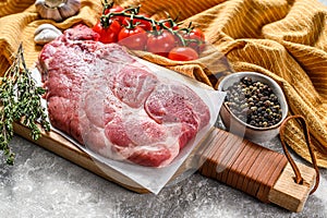 Raw marble pork steak on a wooden chopping Board. Organic meat. Gray background. Top view