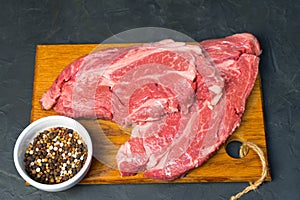 Raw marbled beef steak. Close-up photo on dark background