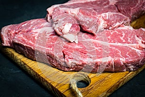 Raw marbled beef steak. Close-up photo on dark background