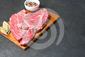 Raw marbled beef steak. Close-up photo on dark background