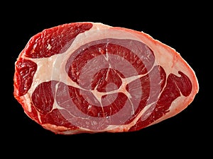 Raw marbled beef steak with white fat against a black background meat