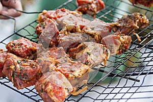 Raw marinaded juicy pork meat in grill grates