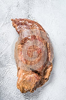 Raw marinated beef tri-tip steak for roast. White background. Top view