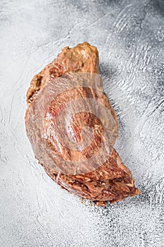 Raw marinated beef tri-tip steak for roast. White background. Top view