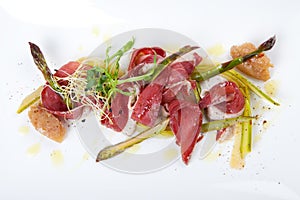 Raw marinated green asparagus with smoked duck breast