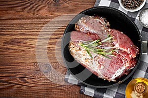 Raw marinated meat on cooking pan