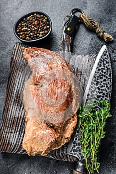 Raw marinated in mustard beef tri-tip steak for bbq. Black background. Top view