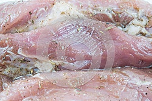 Raw marinated pork chops with spices and herbs,close up