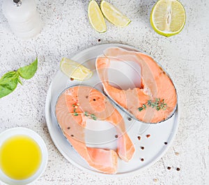 Raw marinated red fish in spices, lime and olive oil in a white plate. Top view