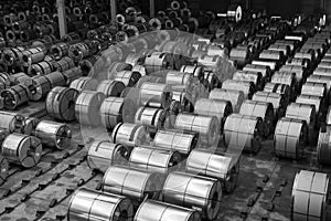 Raw material Handling: Steel coil storing inside a warehouse for exporting to automotive industry plant in black and white.