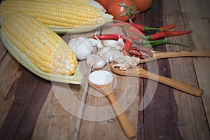 Raw material for making corn salad on wooden plate.