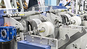 Raw material plastic roll set on support unit shaft for supply or feed to modern automatic blow or injection for continuous